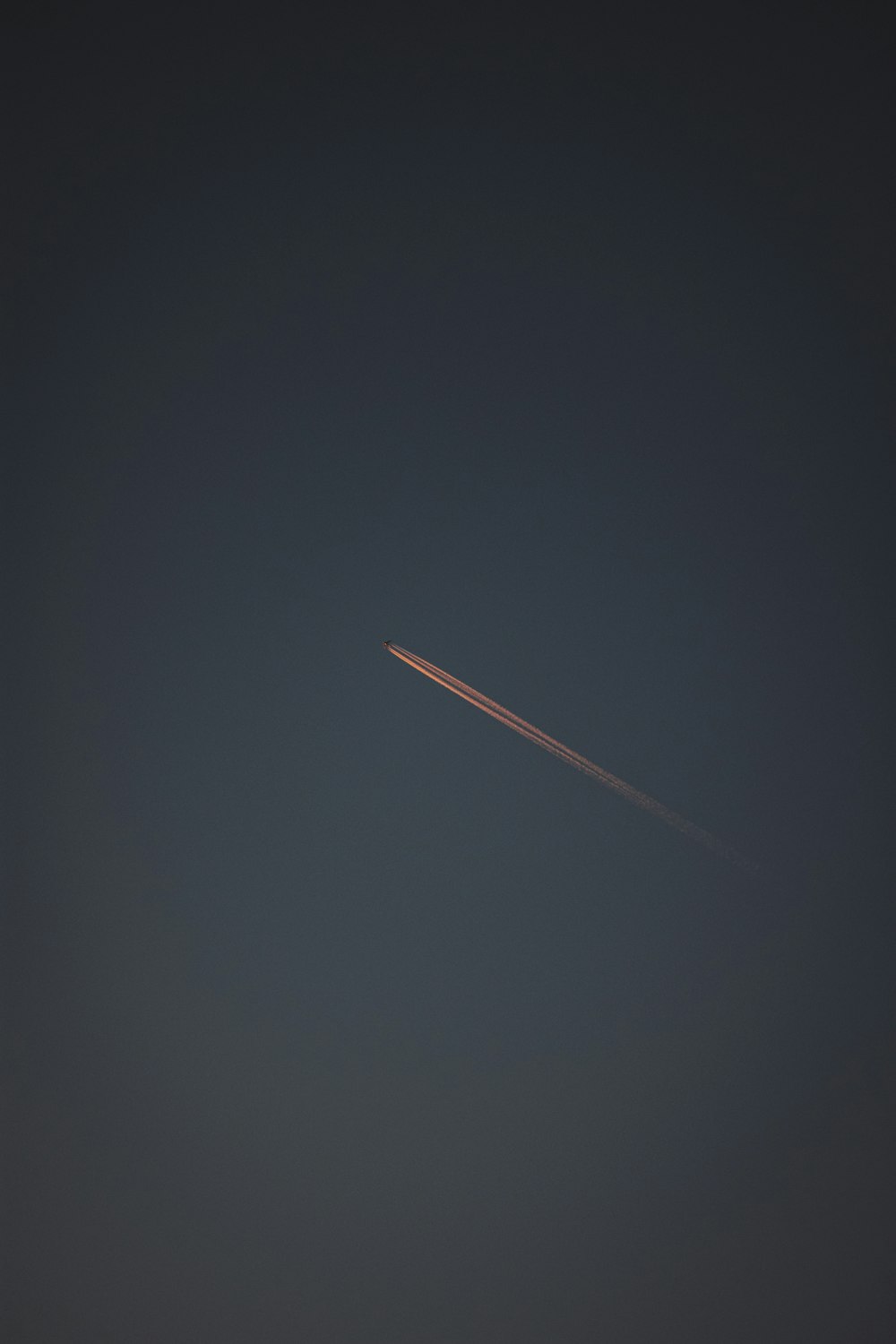 an airplane is flying in the sky at night