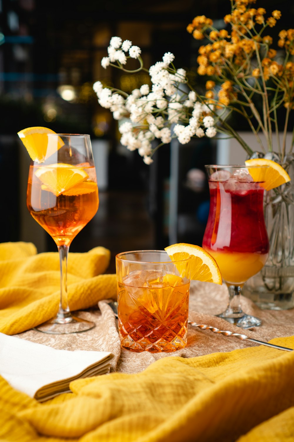 a table topped with glasses filled with drinks