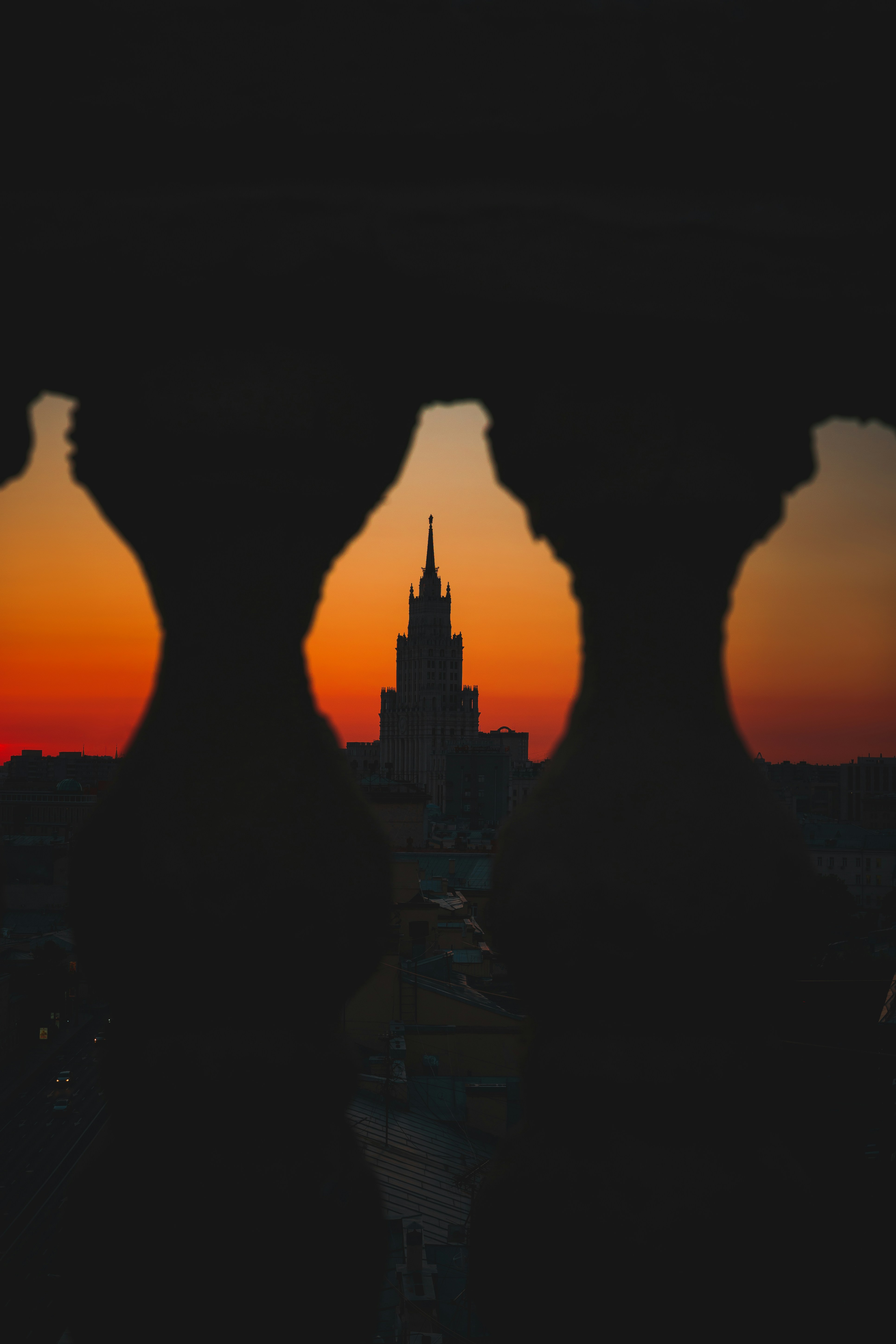 a view of a city from a window at sunset