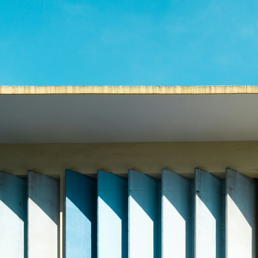 a bird is perched on the ledge of a building