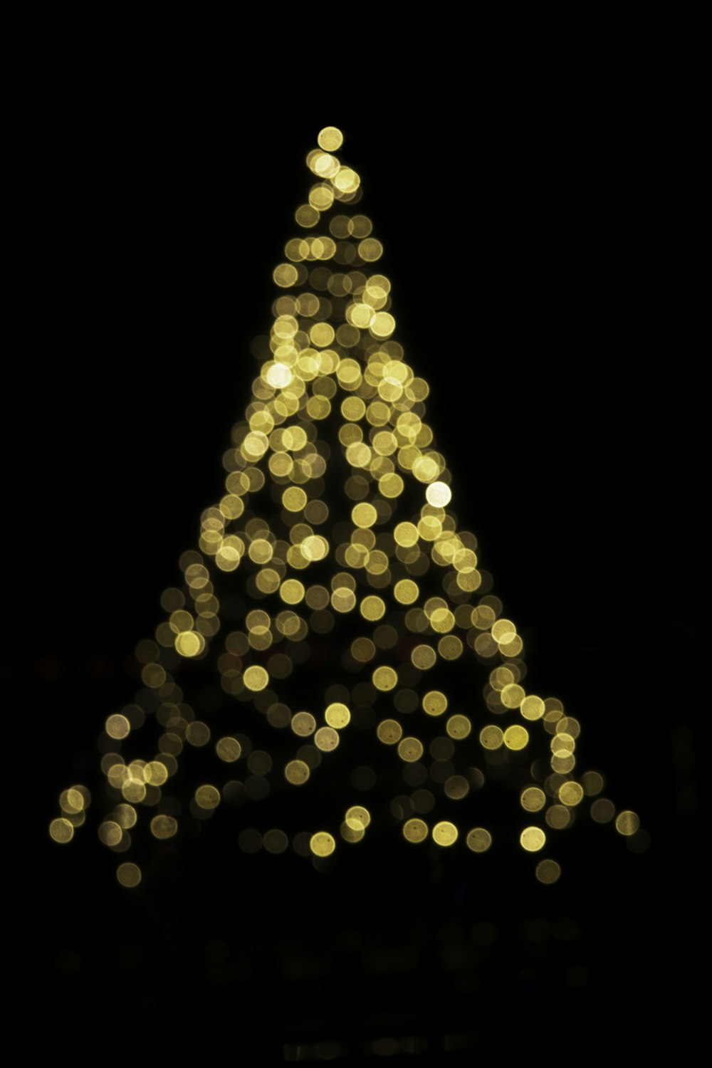 a lit up christmas tree in the dark