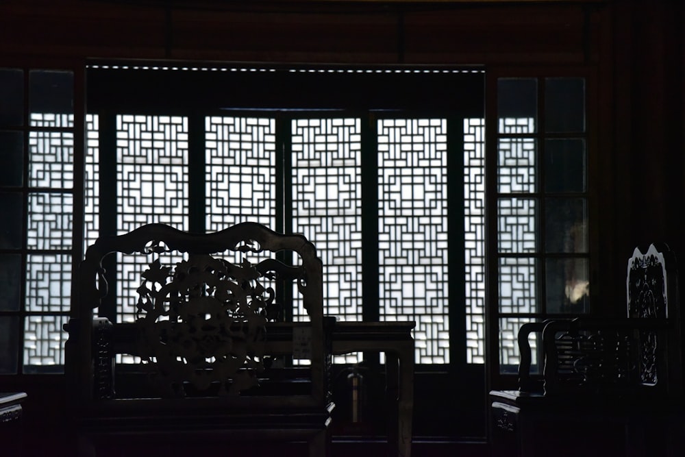 a chair sitting in front of a window in a room