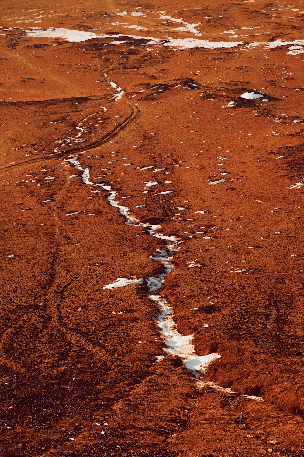 a stream of water running through a barren landscape