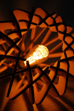 Close-up of a custom acrylic cityscape night light with warm LED illumination highlighting intricate wooden details.