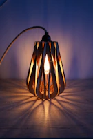 Artistic wooden lamp carved with delicate floral patterns glowing softly in a cozy room.