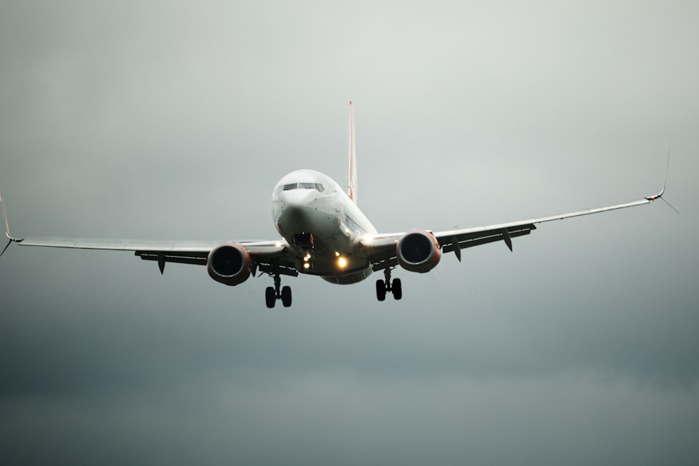 a large jetliner flying through a cloudy sky