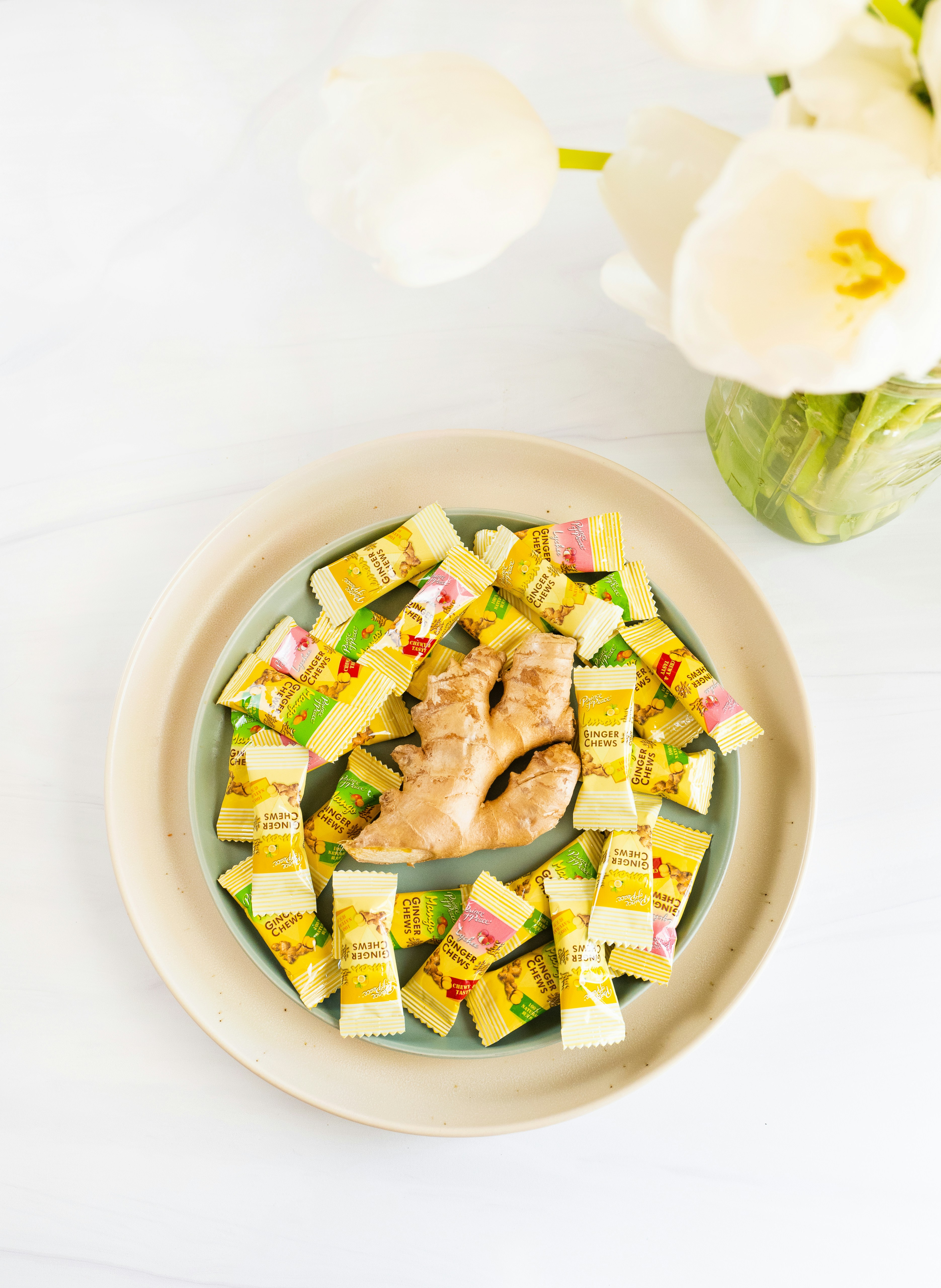 a white plate topped with a chicken covered in candy