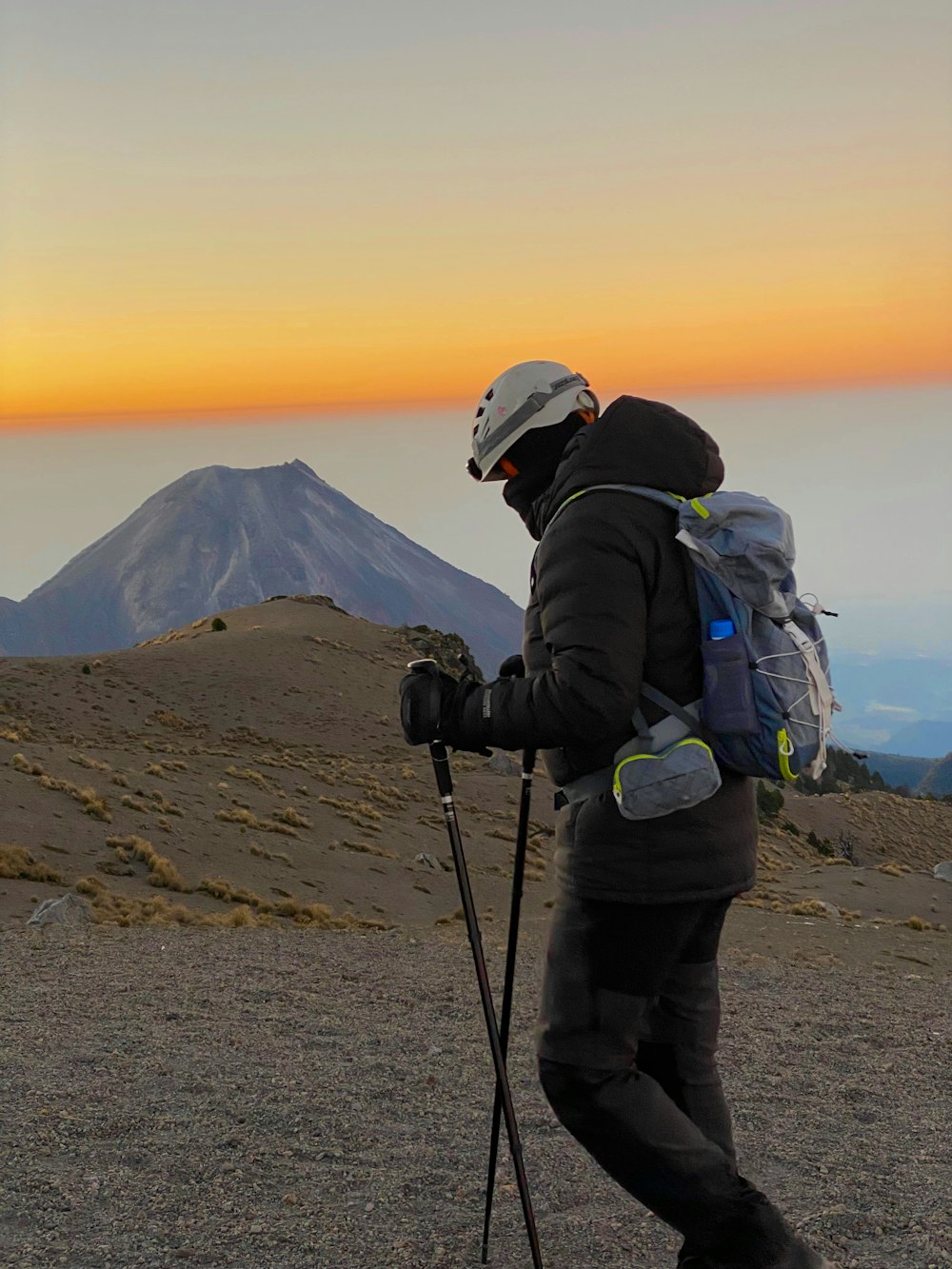 a person with a backpack and skis on a mountain