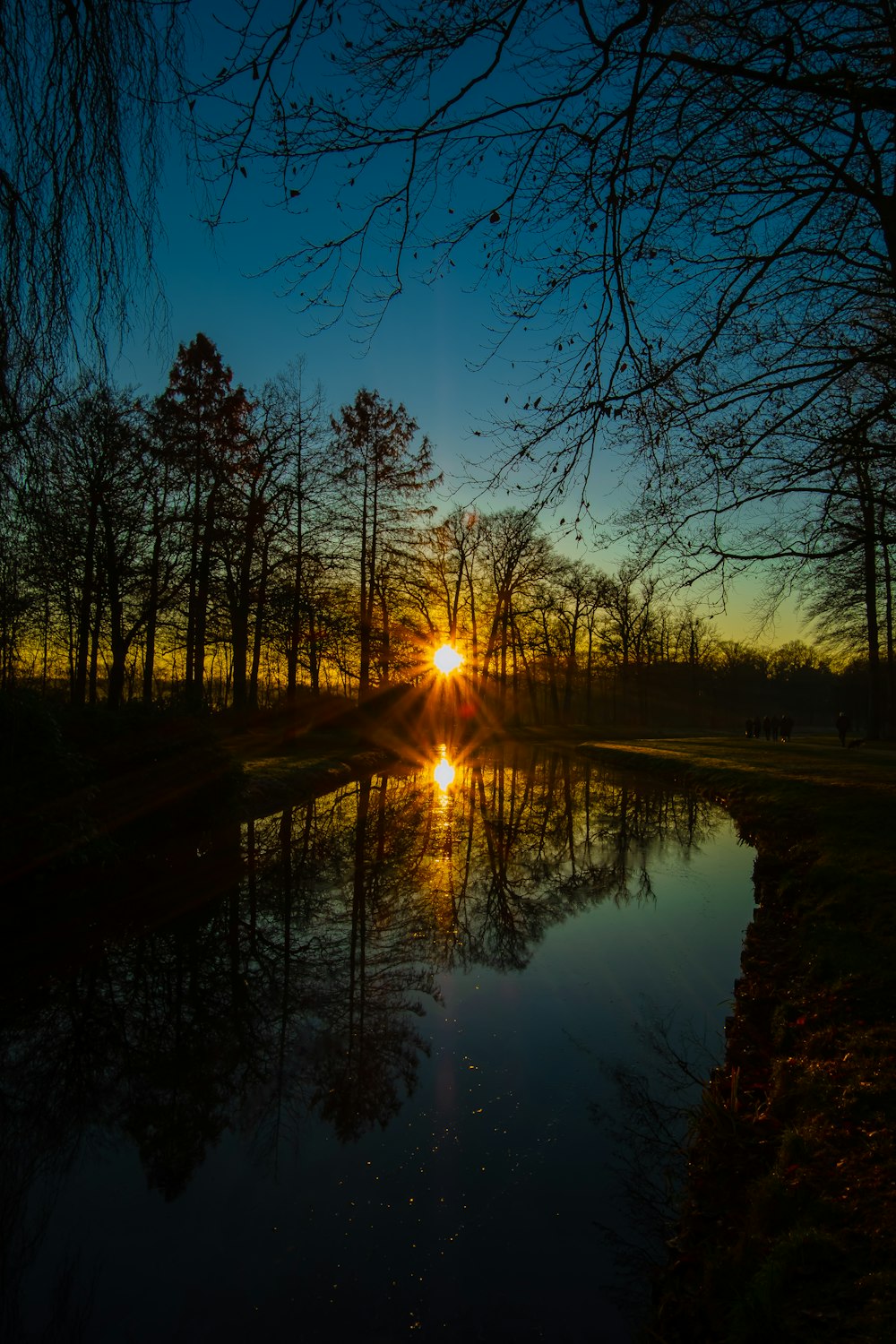 the sun is setting over a body of water