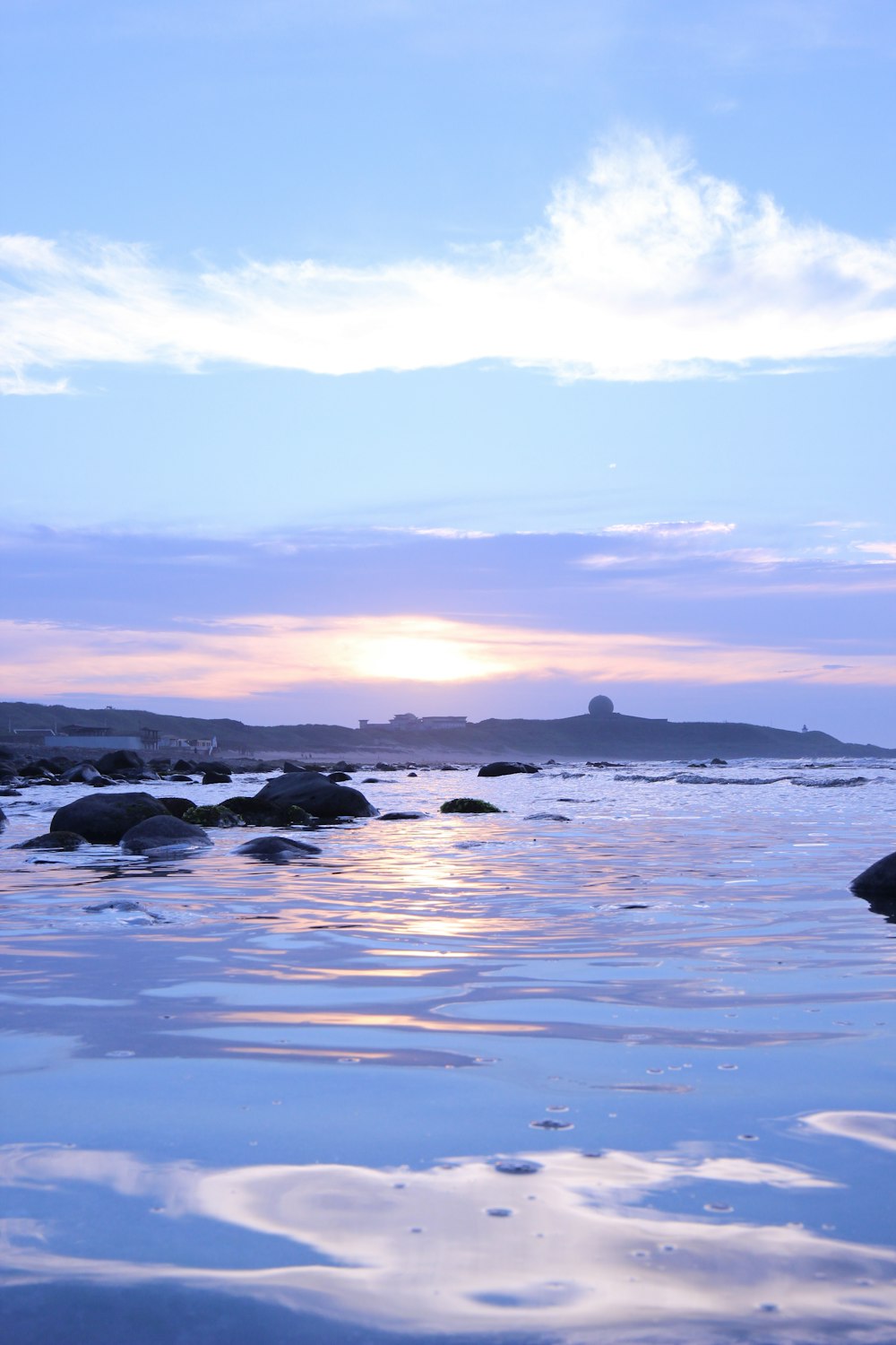 a large body of water with rocks in it