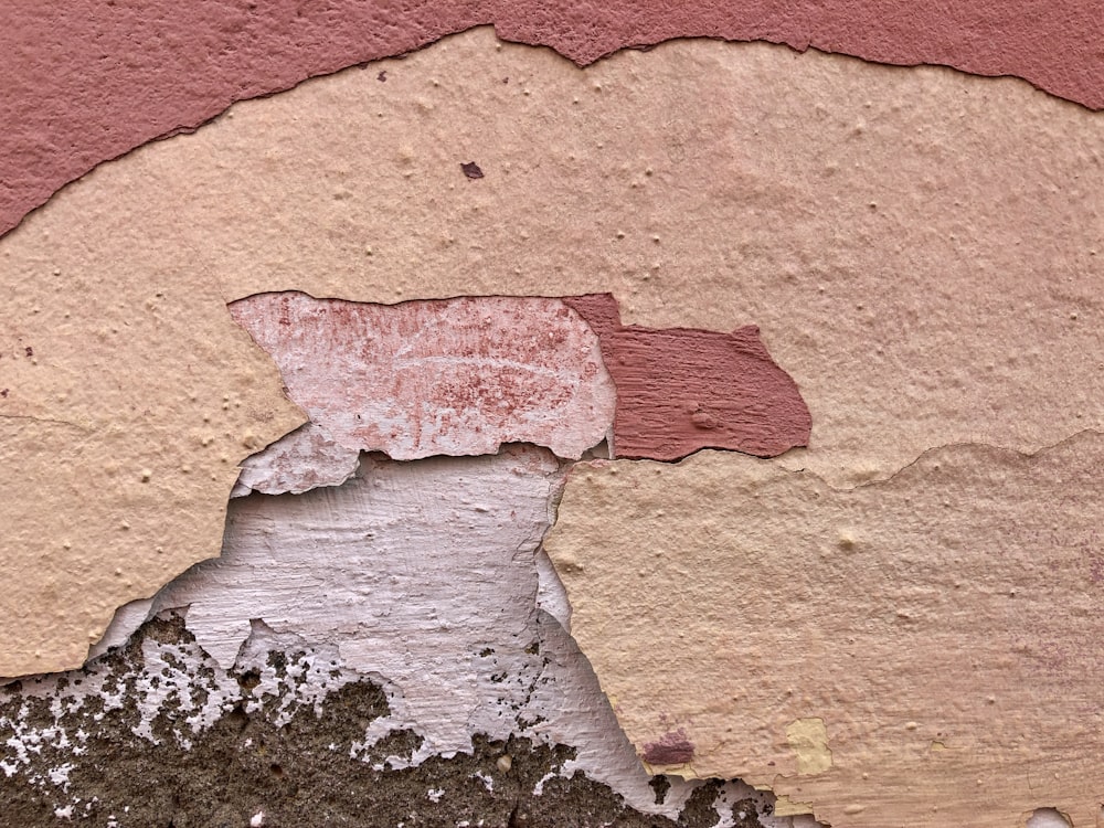 a close up of a peeling paint on a wall