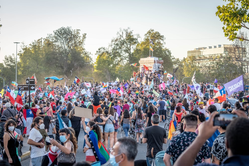 a large group of people walking down a street