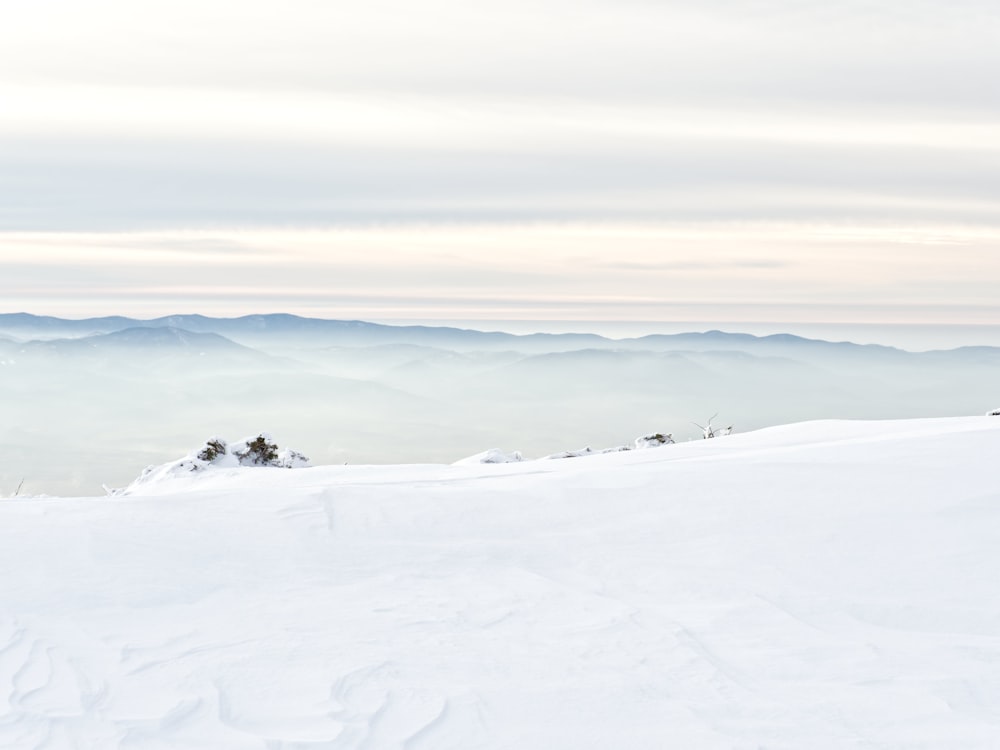 a man riding skis on top of a snow covered slope