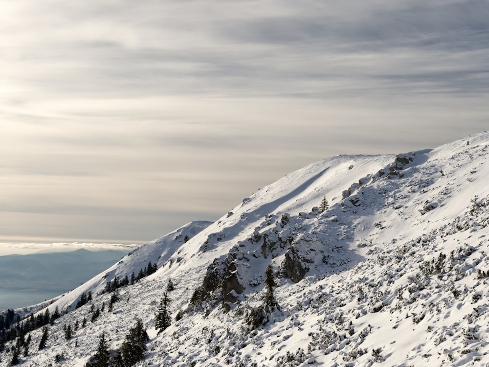 a man riding skis down the side of a snow covered slope