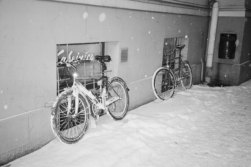 a couple of bikes parked next to a building