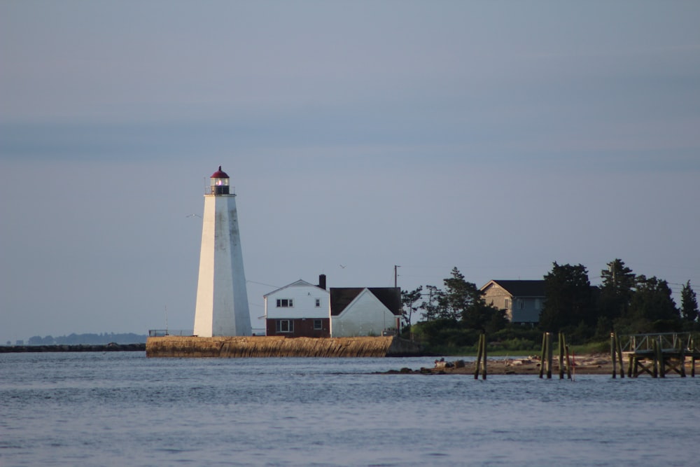 a light house sitting on top of a body of water