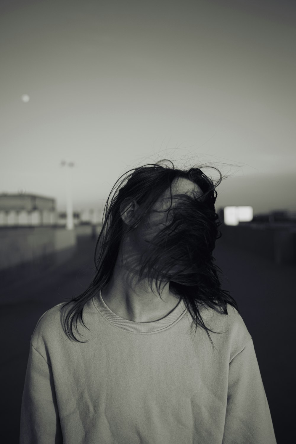 a woman with her hair blowing in the wind