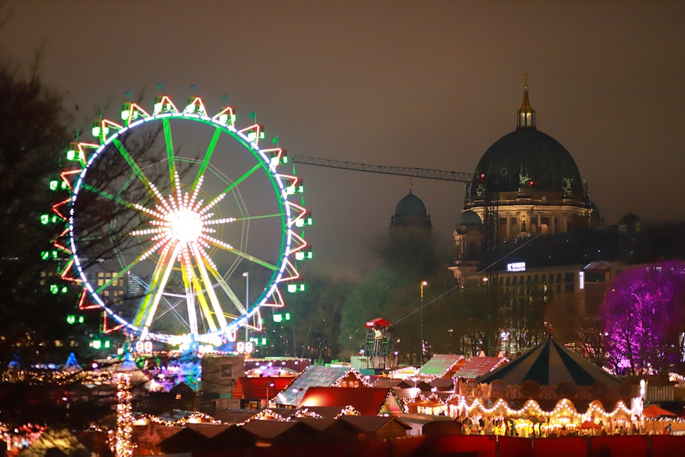 a ferris wheel lit up in the night sky