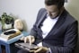 a man in a suit is holding a tablet