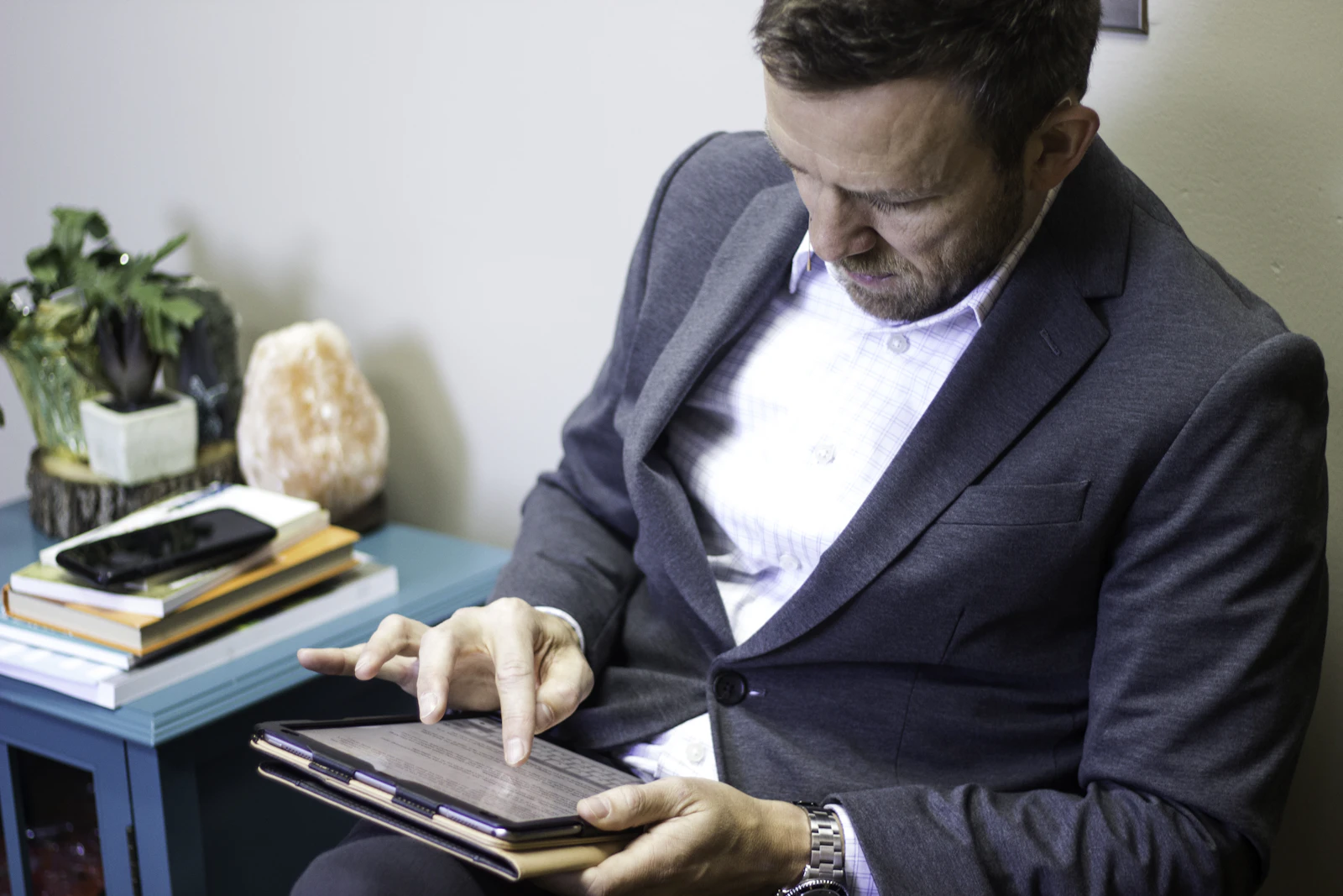 A professional speaker reviewing notes before going on stage