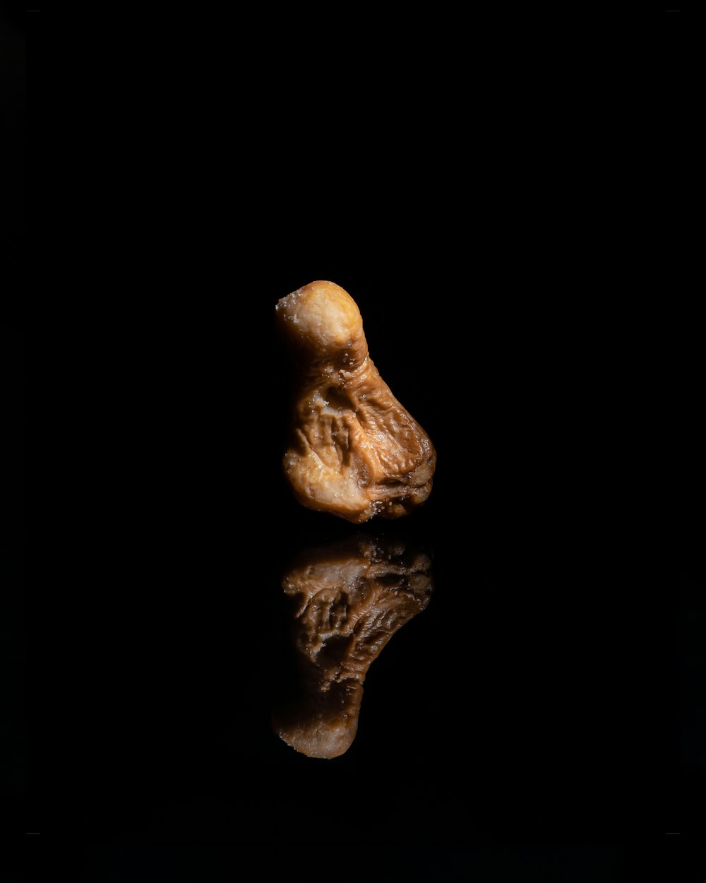 a piece of food sitting on top of a black surface