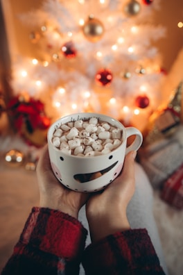 Customers enjoying hot cocoa while shopping during the Christmas sale event.