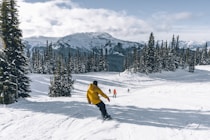 a man riding skis down a snow covered slope
