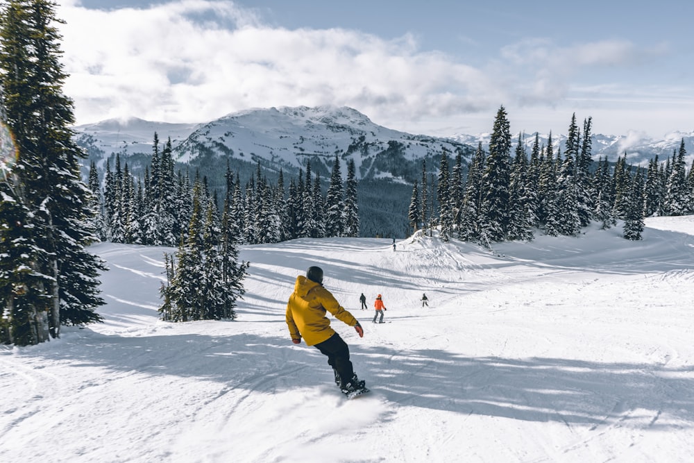 a man riding skis down a snow covered slope