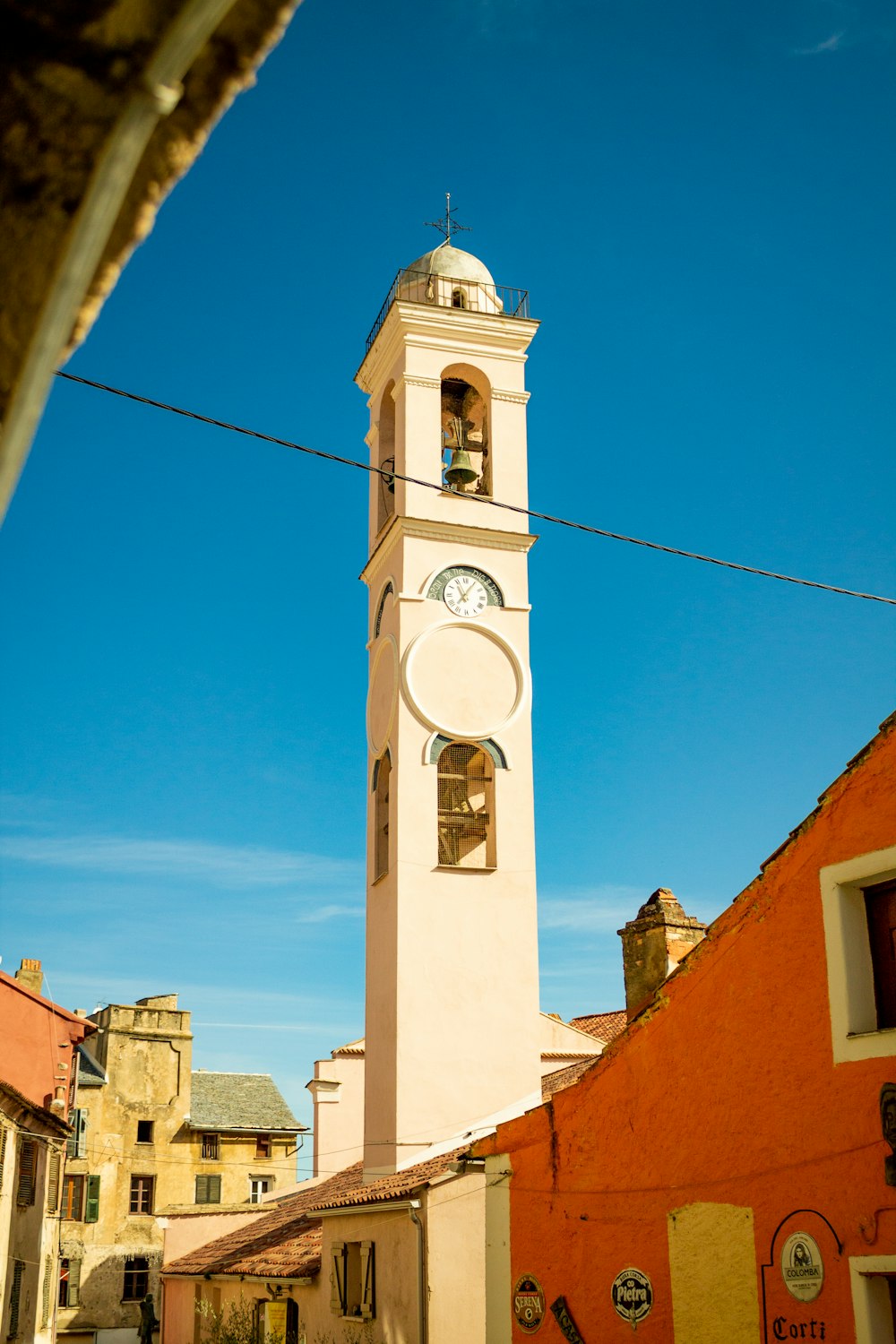 a tall white clock tower towering over a city