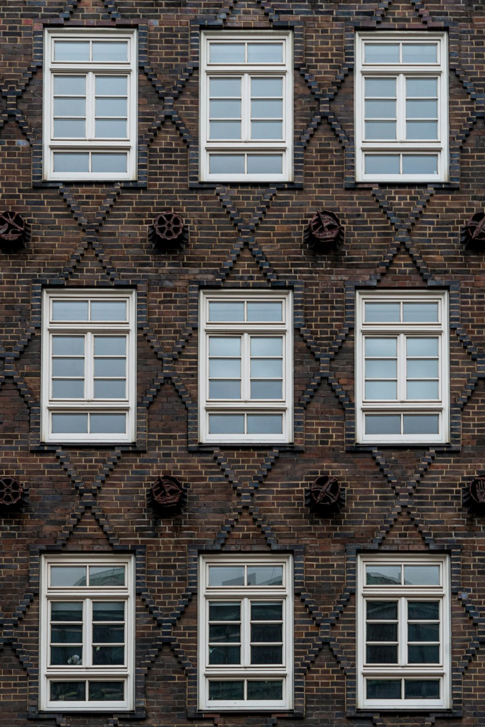 a brick building with many windows and a clock