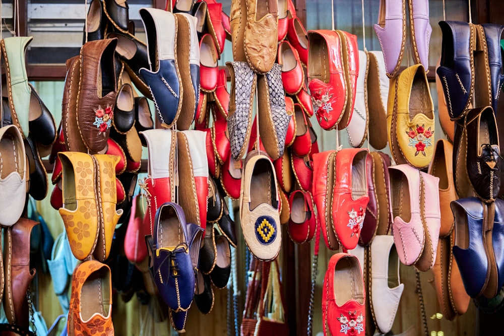 a bunch of shoes that are hanging up