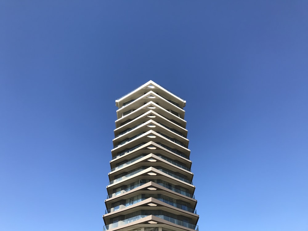 a tall building sitting on top of a lush green field