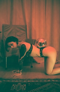 a woman in lingerie laying on a chair