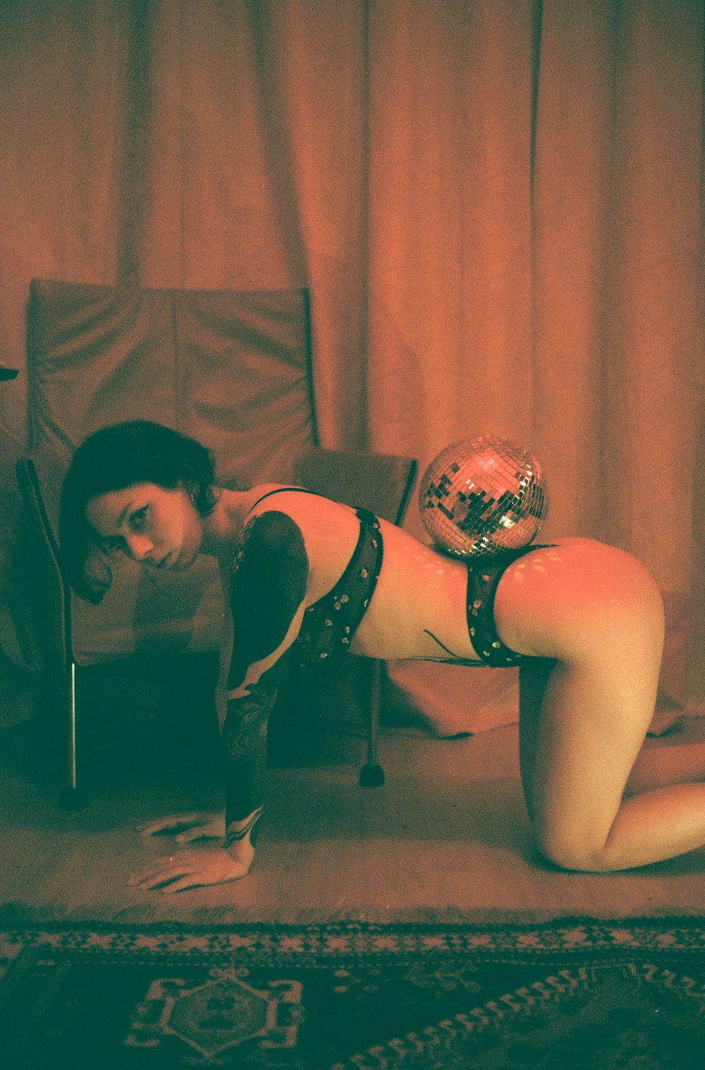 a woman in lingerie laying on a chair