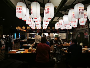 A bustling halal restaurant in downtown Portland with colorful lanterns and happy diners.