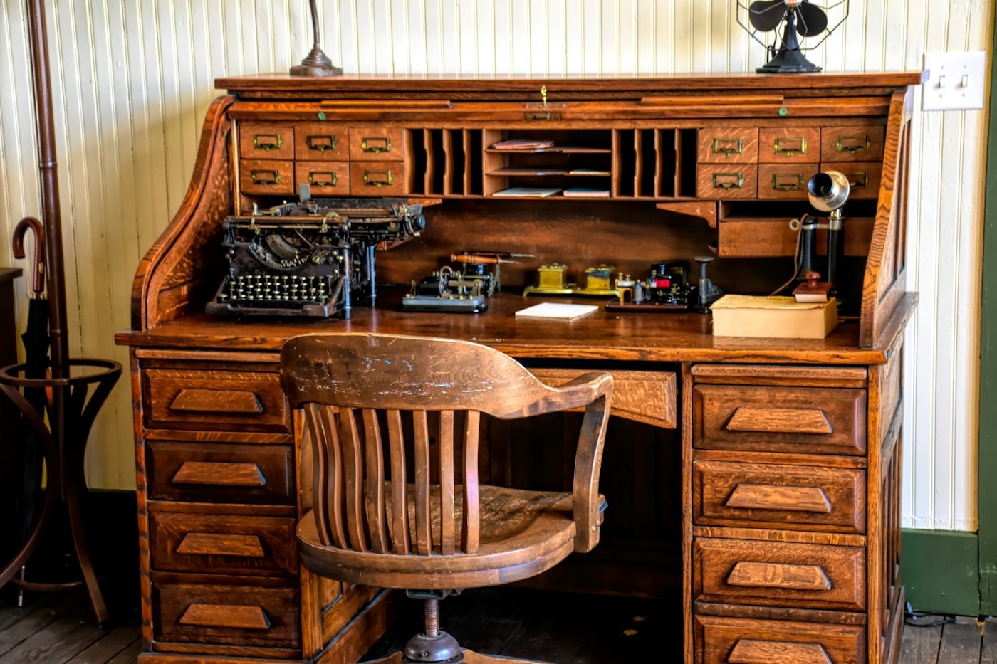 Wooden desk with a vintage typewriter in an office