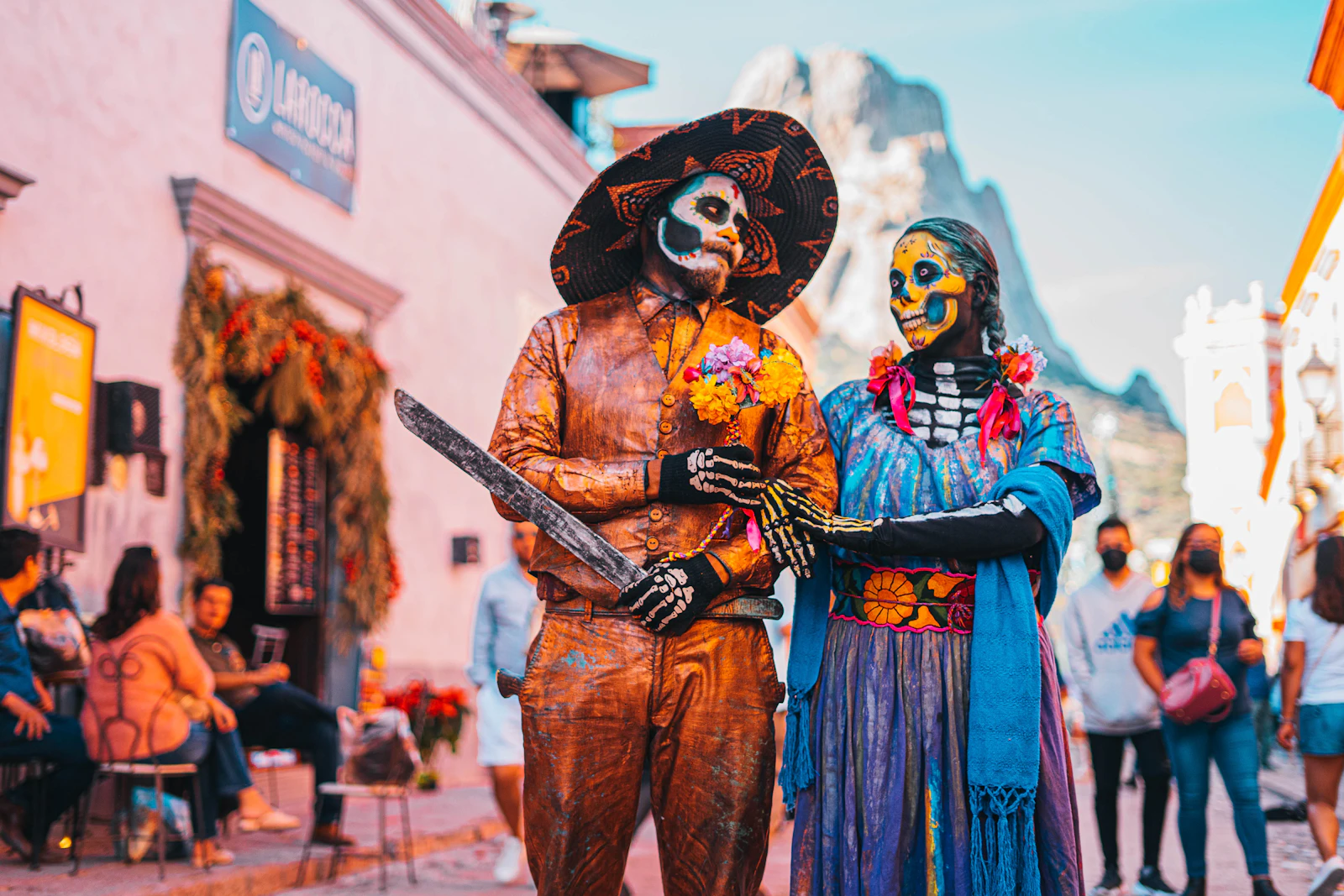 Two figures in Day of the Dead costume on a street in Todos Santos