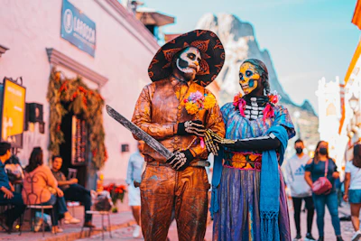 Two figures in Day of the Dead costume on a street in Todos Santos
