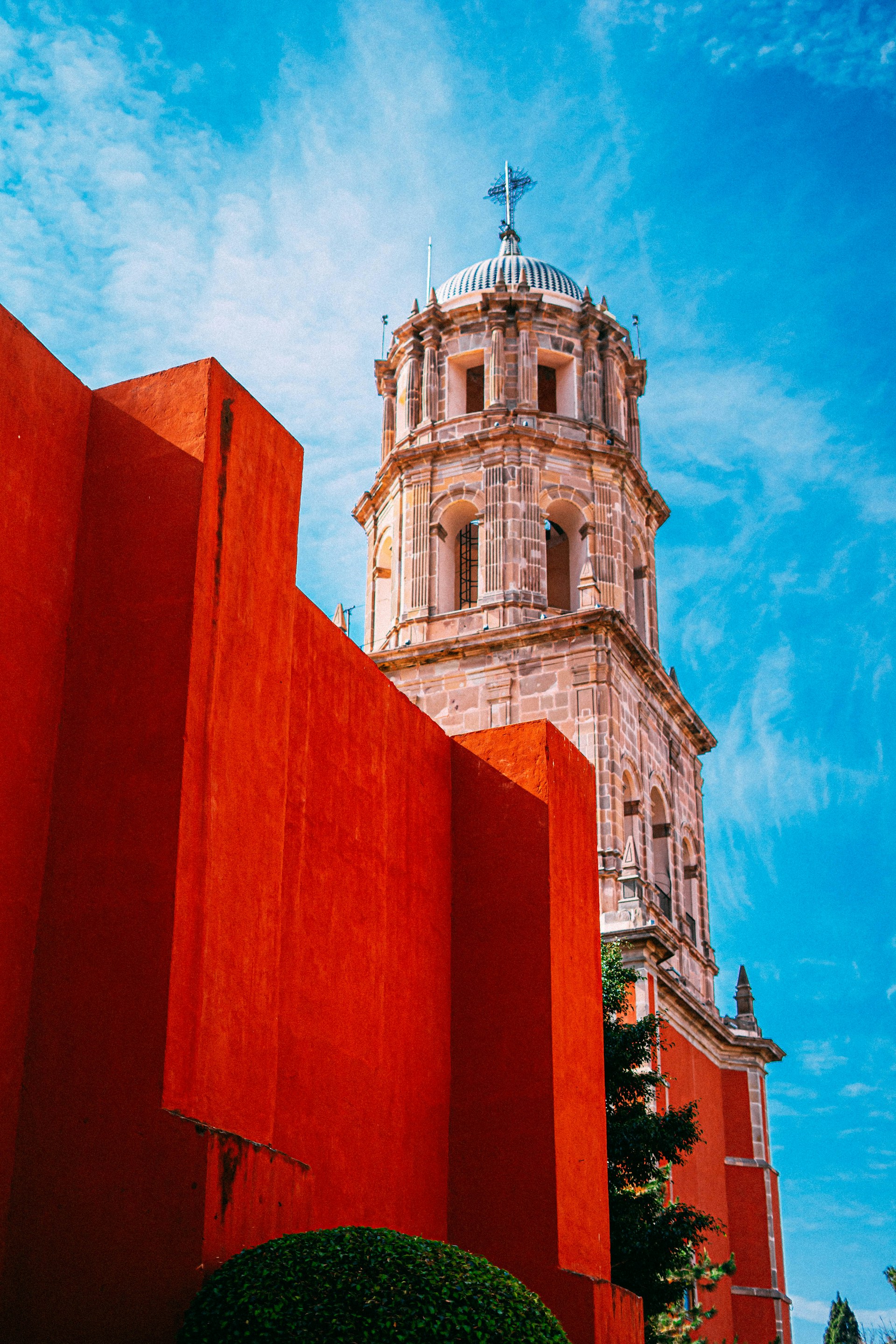 a tall tower with a cross on top of it