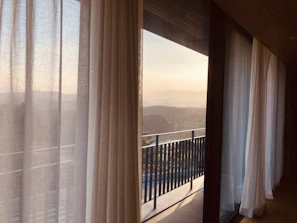 Inviting garden view from a private room balcony with morning light filtering through