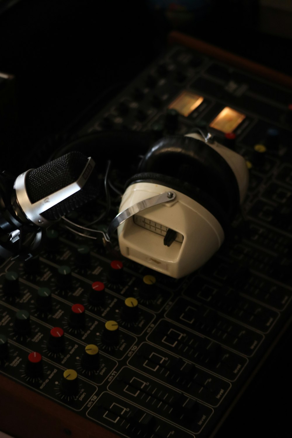 a pair of headphones sitting on top of a sound board