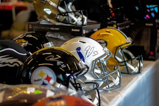 a row of football helmets sitting on top of a table