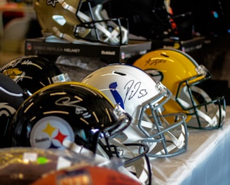 a row of football helmets sitting on top of a table