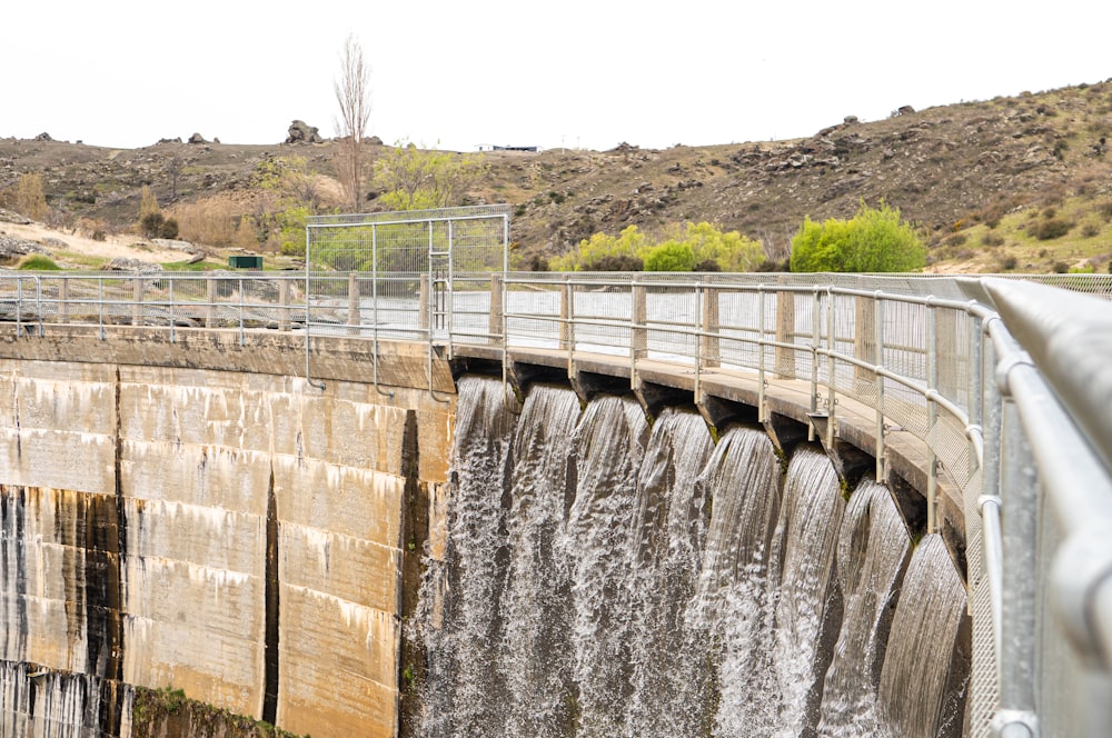 a large dam with water flowing over it