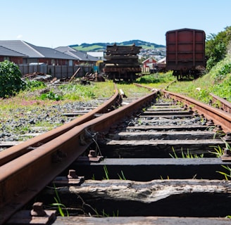 a train track with a bunch of train cars in the background