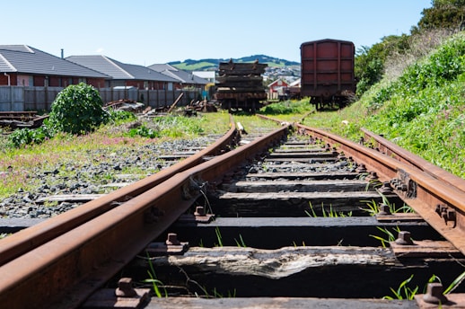 a train track with a bunch of train cars in the background