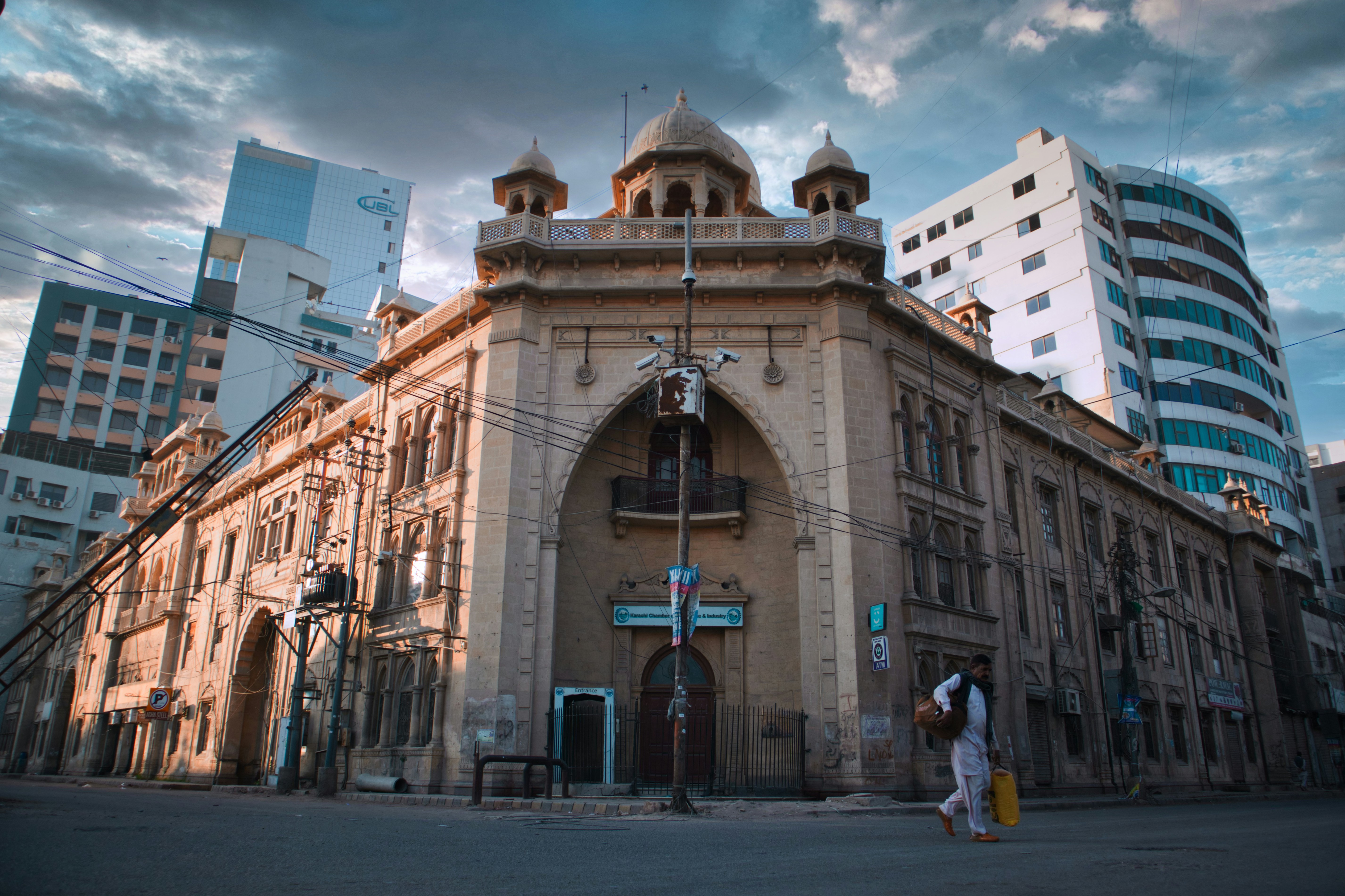 a couple of people walking in front of a building
