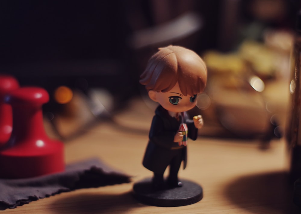 a small figurine of a boy in a suit and tie