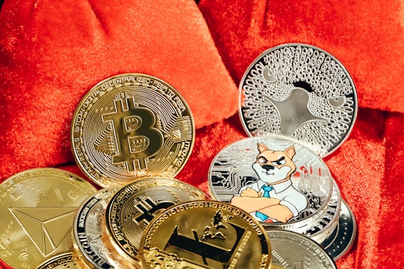 a pile of bitcoins sitting on top of a red blanket