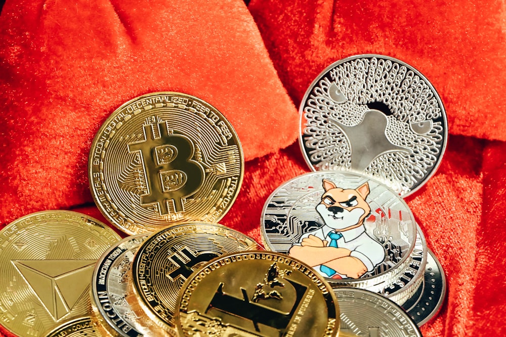 a pile of bitcoins sitting on top of a red blanket